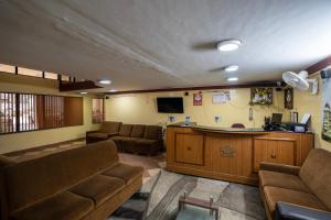 a waiting room with couches and a bar in a hospital at Hotel Vyshak residency in Mysore