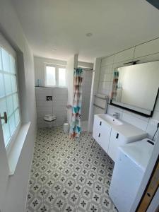 a bathroom with a sink and a toilet at cottages de la Maye in Rue