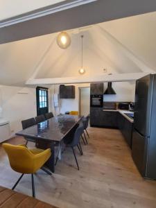 a kitchen and dining room with a table and chairs at cottages de la Maye in Rue