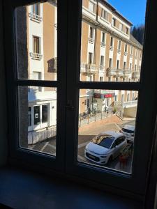 a view from a window of a car parked on a street at Appartement chez la fleuriste in Chaudes-Aigues