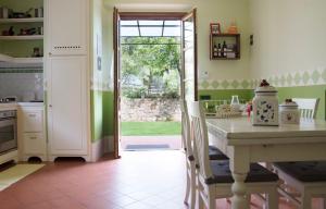 a kitchen with a table and a door to a yard at Il Campano in Collodi