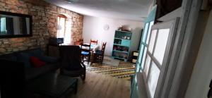 a living room with a couch and a table at 1 Eti And Mia House in Muntić