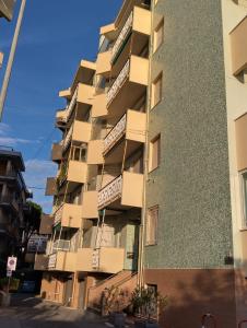 a tall building with balconies on the side of it at Cuorea House ideale per bikers in Loano