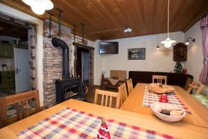a dining room with a table and a wood stove at Cottage Suha in Bohinj