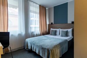 Postel nebo postele na pokoji v ubytování PARK HOTEL VILNIUS