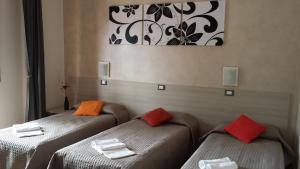 a room with two beds with towels on them at B&B Monté in Montesilvano