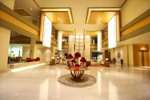 a lobby with a table in the middle of a building at Taj Bangalore in Devanahalli-Bangalore
