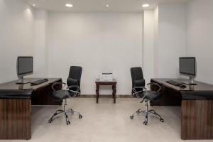 una camera con 4 scrivanie con computer e sedie di InterContinental Taif by IHG a Taif