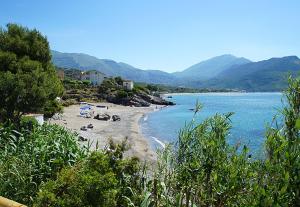 a beach with a group of boats in the water at Case Vacanze Torre Petrosa in Villammare