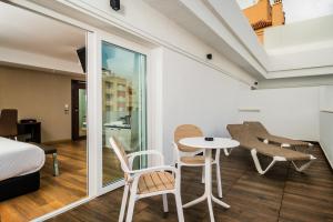 a room with a bed and a table and chairs at MB Boutique Hotel - Adults Recommended in Nerja +37 photos