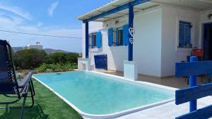 a swimming pool in the backyard of a house at Kampos Seaside Village in Kampos Paros