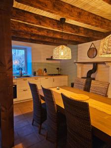 a kitchen with a wooden table and chairs at Gîte d'Artisan in Pionsat