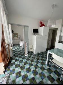 a living room with a table and a room at Bellissimo appartamento frontemare con terrazza in Caorle