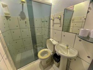 a bathroom with a toilet and a sink at Pousada Vila da Praia in Santarém +43 photos