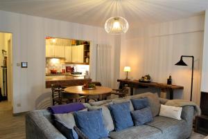 a living room with a couch and a table at Cosy gezellig app met aparte gastenkamer op 30meter van strand privé garage in Koksijde