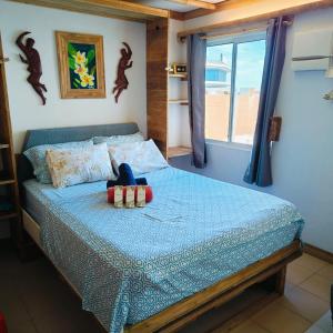 a bedroom with a bed with a blue comforter at Gallardo Homestay at Marina Spatial Condo in Dumaguete +51 photos