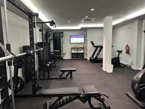 a gym with several tread machines in a room at M'AR De AR Auria in Lisbon