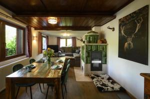 a dining room with a table and a fireplace at Jägerlodge am Waldrand in Grainau in Grainau