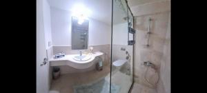 a bathroom with a sink and a shower at Dream Apartment in Salalah +28 photos