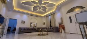 a living room with a couch and a table at happy villa ras al khaimah chalet in Ras al Khaimah