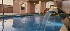 a water fountain in front of a house at happy villa ras al khaimah chalet in Ras al Khaimah