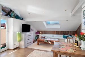 a living room with a couch and a tv at Haus Riedel in Garmisch-Partenkirchen
