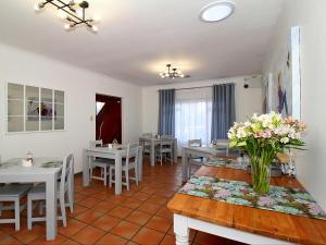 a dining room with white tables and white chairs at Glennies Guesthouse in Somerset West