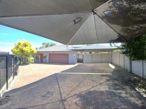 a large white umbrella in front of a house at Glennies Guesthouse in Somerset West +12 photos