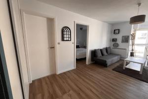 a living room with a couch and a table at Soh Rent Appartement strasbourg Neudorf ménagerie TV - Wifi in Strasbourg