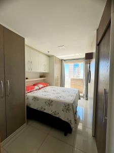 a bedroom with a bed and a large window at Apartamento no Shopping em Brasília DF in Brasilia