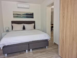 a bedroom with a large bed with white sheets at Großes Ferienhaus Zur Alleinigen Nutzung Mit Pool in Bilice +14 photos
