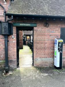 an entrance to a brick building with a parking meter at George And Dragon Place in Chester