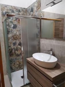 a bathroom with a sink and a shower at Helle Wohnung In Santa Maria Al Bagno in Santa Maria al Bagno +9 photos