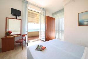Postel nebo postele na pokoji v ubytování Hotel Caravel