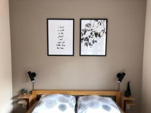 a bedroom with two pictures on the wall and a bed at Fewo 5 Jahreszeiten in Bell
