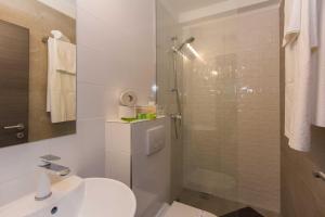 a bathroom with a shower and a toilet and a sink at B&B Vibe in Split