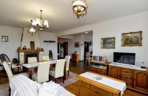a dining room and living room with a table and chairs at Ferienhaus Sofija in Vrtlinovec