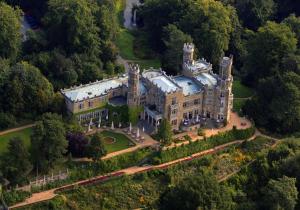 an aerial view of a mansion with trees at Hotel Schloss Eckberg in Dresden