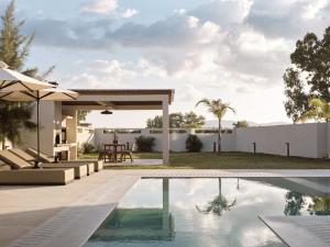 a swimming pool in the backyard of a house at Vorto Luxury Villas, a Signature Island Retreat, By ThinkVilla in Zakynthos