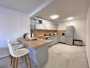 a kitchen with a counter and a refrigerator at Apartment Bonum with Private Pool in Šilo