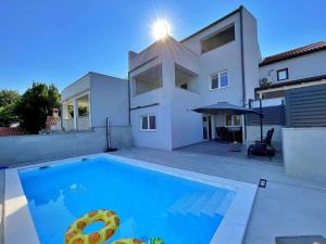 a swimming pool in front of a house at Apartment Bonum with Private Pool in Šilo +33 photos