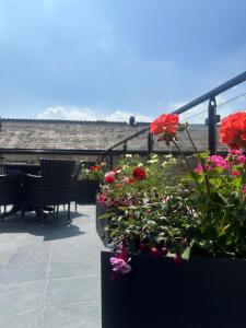 a balcony with flowers and a piano on a patio at The Royal Station Hotel in Carnforth