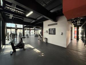 a gym with treadmills and machines in a room at Loft-Piscina-Gym-Ludoteca in Guadalajara