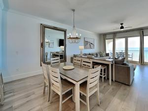 a dining room and living room with a table and chairs at Adagio #403B in Santa Rosa Beach