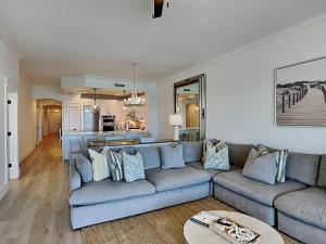 a living room with a couch and a kitchen at Adagio #403B in Santa Rosa Beach