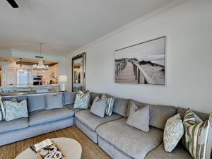 a living room with a couch and a kitchen at Adagio #403B in Santa Rosa Beach