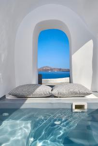 A bed or beds in a room at Amaya Sensational Villa Caldera View-Outdoor Hot Tub Oia Santorini