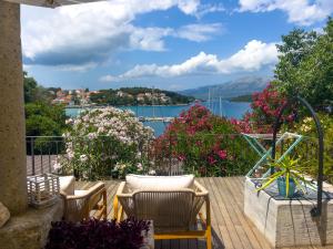a balcony with chairs and a view of a lake at ECO Aparthotel The Dreamers's Club in Lumbarda