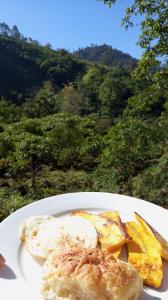 a plate of food with eggs and potatoes on a table at Cabaña el Chapuzón montaña y rio, lugar fresco in Cedral