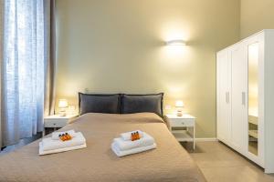a bedroom with a bed with two pillows on it at Darsena Flat in Milan